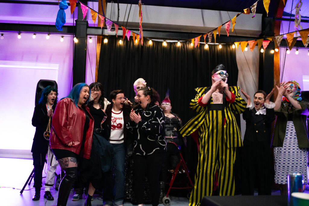 Sapphic Panic celebrating as drag queen Fatt Butcher announces them as winner